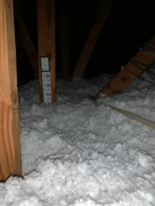 TLS Energy Savers worker installing blown-in fiberglass in a St. Petersburg Old Northeast attic.